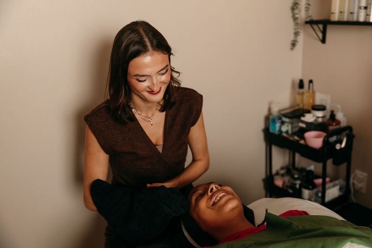 Client relaxing during a facial with an Alpha Chiropractic esthetician